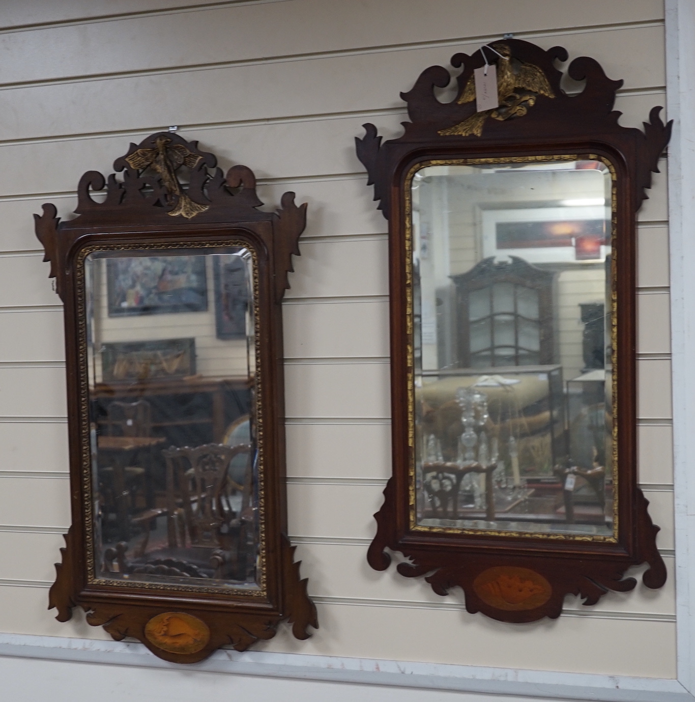 Two George III style inlaid mahogany fret cut wall mirrors, larger width 52cm, height 90cm
